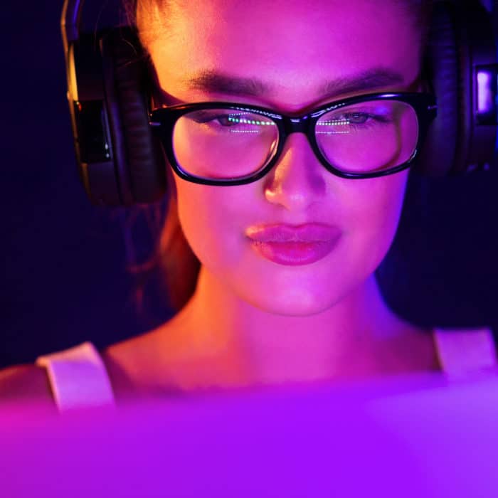 Gamer girl playing video game, wearing headset