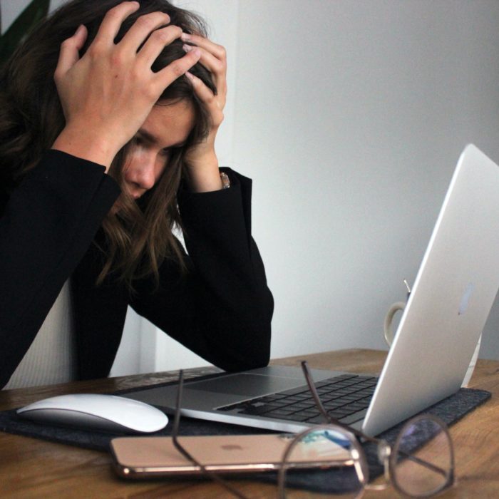 Frustrated Woman In Front of a Laptop