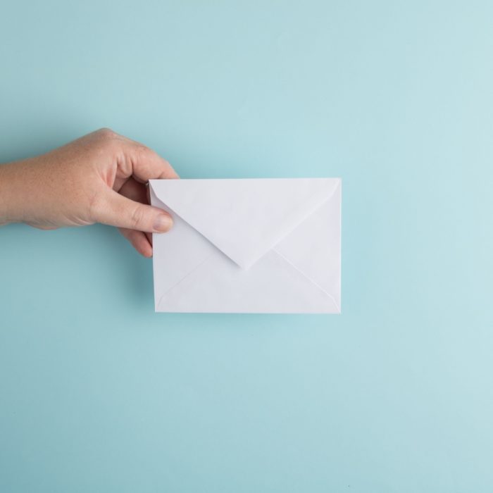 Person Holding White Envelope