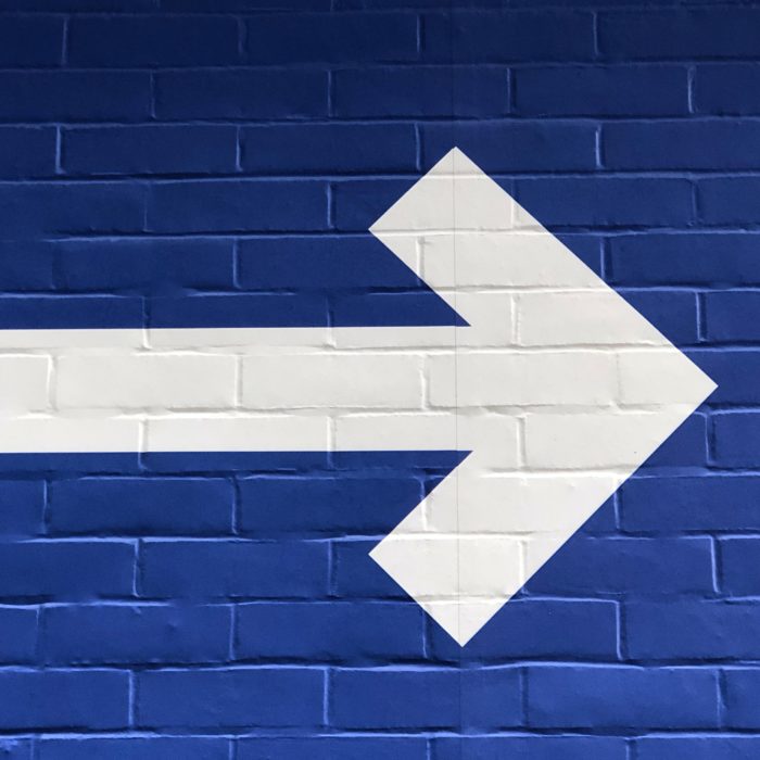 Arrow Sign on Blue Background