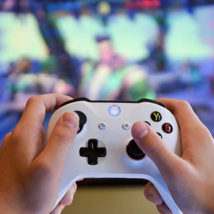 close up of boy hands playing xbox game