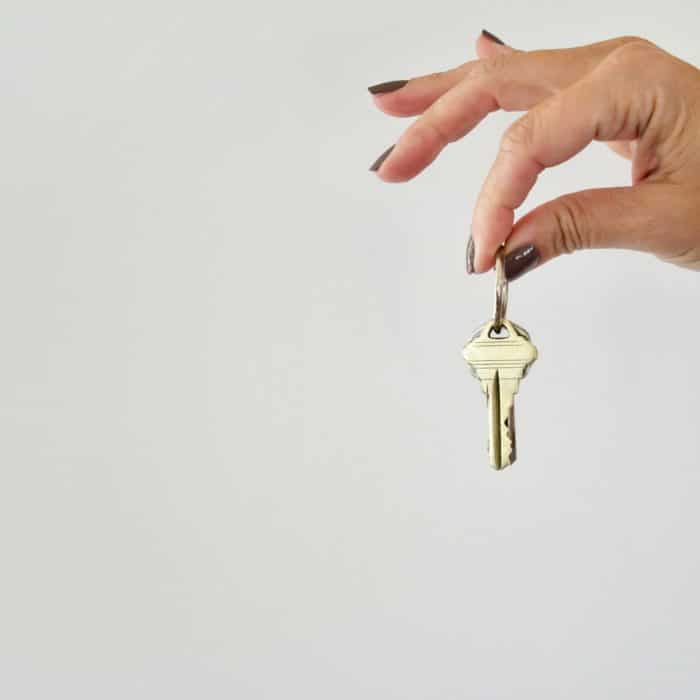 someone holding keys on a white background