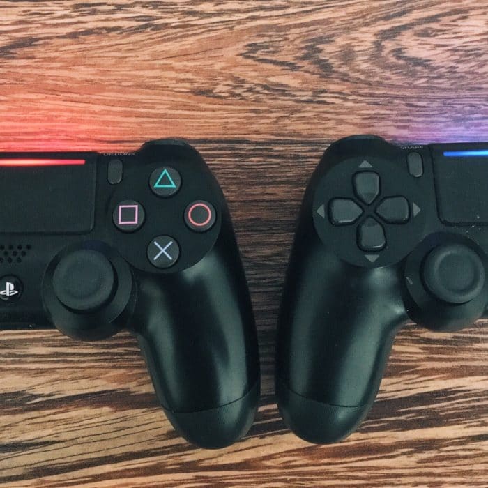 two ps joysticks on a wooden background