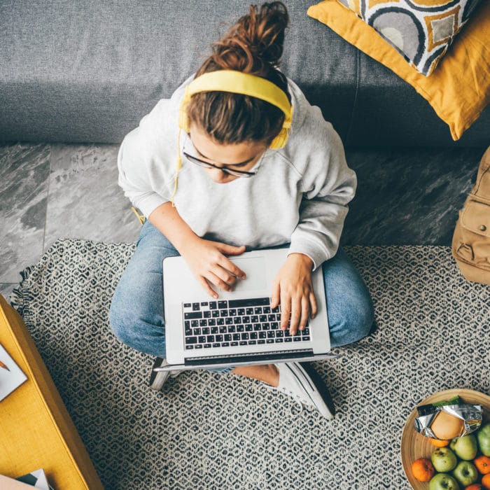 young woman using laptop computer at home